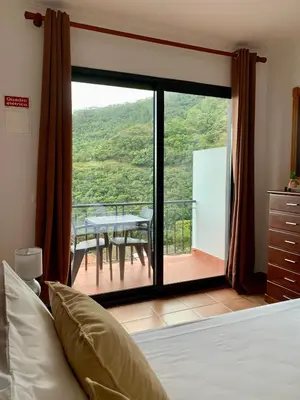 a white bathroom with a toilet and a sink at Seaside & Levada Escape in Machico