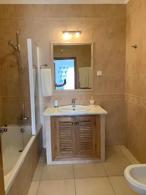 a bathroom with a sink and a tub and a mirror at Luxury 4 Bedroom Algarve Villa with Private Pool in Budens