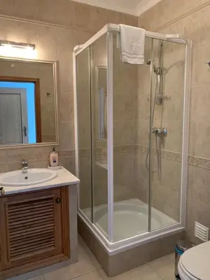 a bathroom with a shower and a sink at Luxury 4 Bedroom Algarve Villa with Private Pool in Budens