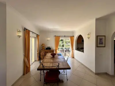 a dining room with a wooden table and chairs at Luxury 4 Bedroom Algarve Villa with Private Pool in Budens