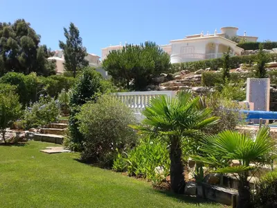 a garden with plants and a house in the background at Luxury 4 Bedroom Algarve Villa with Private Pool in Budens