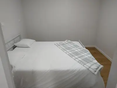 a bedroom with a white bed with a blanket on it at charnecas house in Gaula