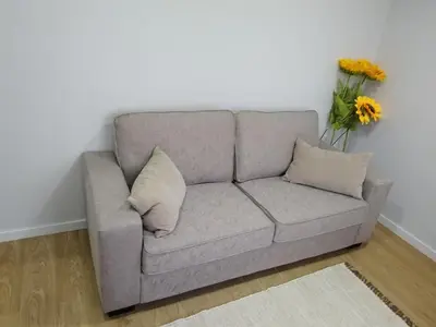 a grey couch in a room with a vase of flowers at charnecas house in Gaula
