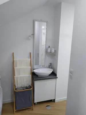 a bathroom with a white sink and a mirror at charnecas house in Gaula