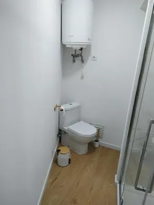 a white bathroom with a toilet and a sink at charnecas house in Gaula