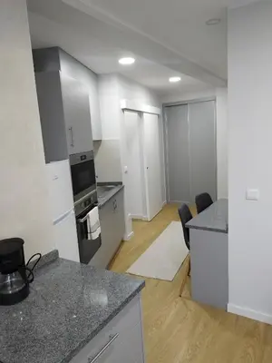 a kitchen with white cabinets and a counter top at charnecas house in Gaula