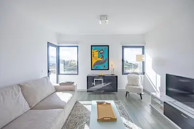 a living room with a couch and a tv at Lux Mare Funchal by YOUR KEY MADEIRA in Funchal