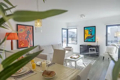 a living room with a couch and a table at Lux Mare Funchal by YOUR KEY MADEIRA in Funchal