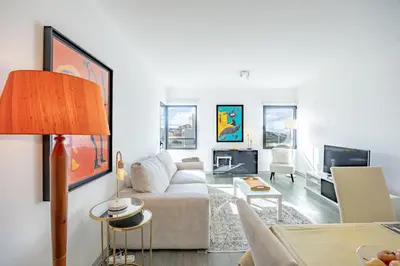 a living room with a couch and a tv at Lux Mare Funchal by YOUR KEY MADEIRA in Funchal