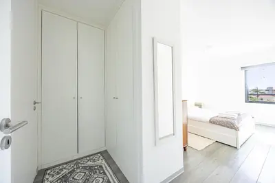 a white room with a door and a bedroom at Lux Mare Funchal by YOUR KEY MADEIRA in Funchal