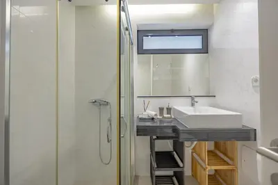 a bathroom with a sink and a shower at Lux Mare Funchal by YOUR KEY MADEIRA in Funchal