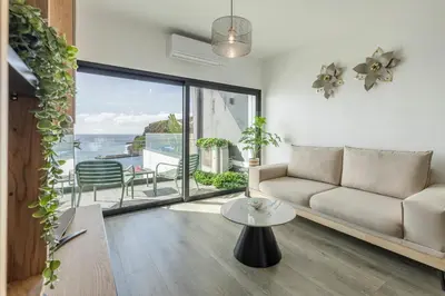 a living room with a couch and a table at Alma do mar luxury - Ocean front in Gaula