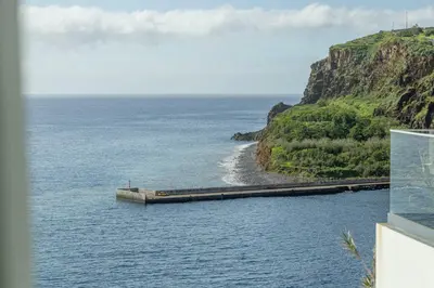 a barge in the water next to a beach at Alma do mar luxury - Ocean front in Gaula