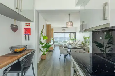 a kitchen and dining room with a dining table at Alma do mar luxury - Ocean front in Gaula