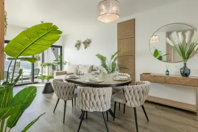 a dining room with a table and chairs and a mirror at Alma do mar luxury - Ocean front in Gaula