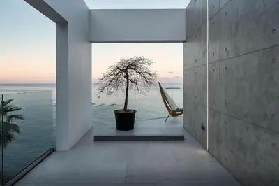 a room with a window with a tree and a chair at Aurora Residence - Ultra Luxury Ocean Cliff Edge Retreat in Arco da Calheta