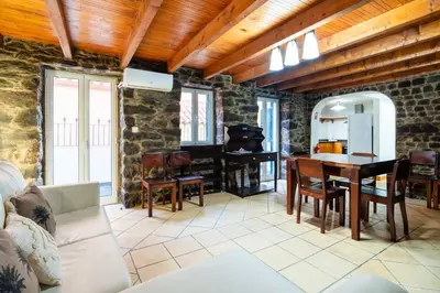 a living room with a table and a stove at GuestReady - Casa Martins in Machico