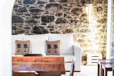 a living room with a white couch with palm trees on it at GuestReady - Casa Martins in Machico