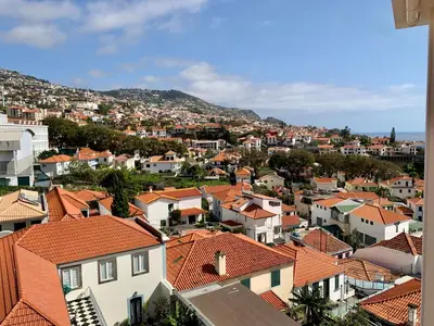 a view of a city with houses and roofs at Residencial do Vale in Funchal