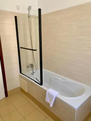 a bathroom with a tub and a toilet and a sink at Residencial do Vale in Funchal