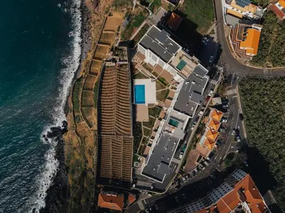 an aerial view of the ocean and buildings at Atlantic Residence Pool & Ocean View in Câmara de Lobos