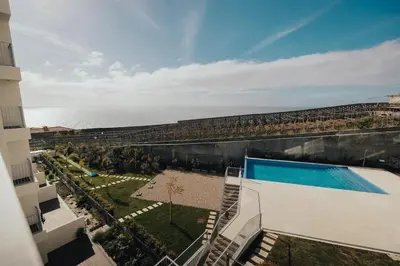 an aerial view of a building with a swimming pool at Atlantic Residence Pool & Ocean View in Câmara de Lobos