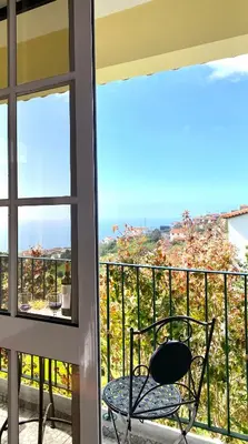 a chair sitting on a balcony with a view at 