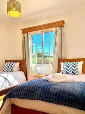 a bedroom with two beds and a window at 