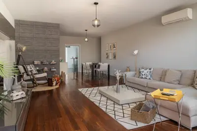 a living room with a couch and a table at Stay Orange Modern Apartment in Funchal in Funchal