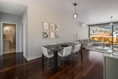 a kitchen and living room with a table and chairs at Stay Orange Modern Apartment in Funchal in Funchal