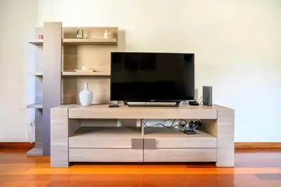 a living room with a couch and a ceiling fan at Ocean Gardens Apartment by Mth in Caniço