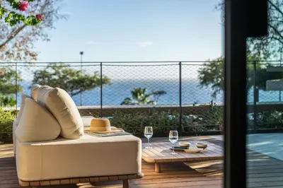 a living room with a couch and a table with wine glasses at Savoy Monumentalis XI Luxury with sea view in Funchal