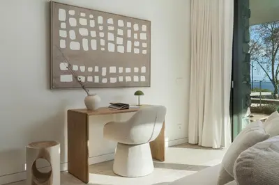 a living room with a white chair and a table at Savoy Monumentalis XI Luxury with sea view in Funchal