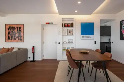 a living room with a table and a couch at Monumental Alta Vista Panoramic View Balcony in Funchal