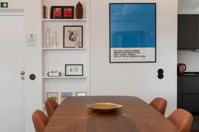 a dining room with a wooden table and chairs at Monumental Alta Vista Panoramic View Balcony in Funchal