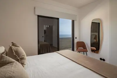 a bedroom with a bed and a view of the ocean at Monumental Alta Vista Panoramic View Balcony in Funchal