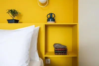 a yellow room with a picture on the wall at Horizon Madeira View in Funchal
