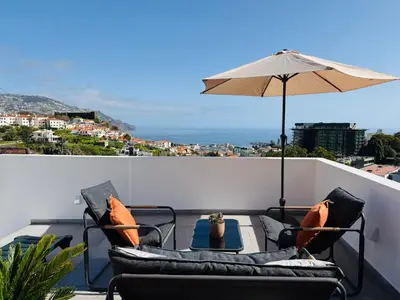 a bedroom with yellow walls and a bed with white pillows at Horizon Madeira View in Funchal
