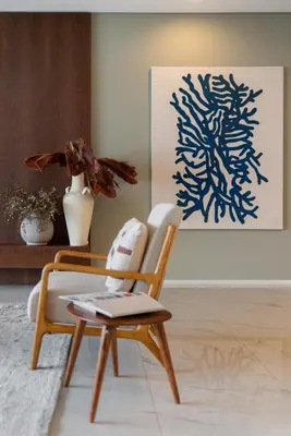 a chair and a table in a living room at Arbor Villa: Nature Retreat in Campanário