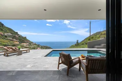 a villa with a pool and a view of the ocean at Arbor Villa: Nature Retreat in Campanário