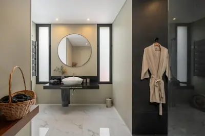 a bathroom with a sink and a mirror at Arbor Villa: Nature Retreat in Campanário