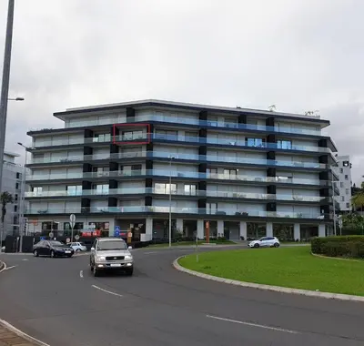 a large building with cars parked in a parking lot at Pilot Ocean View in Funchal