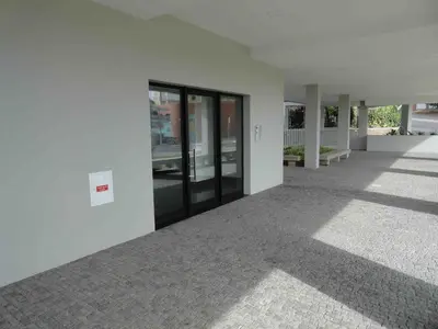 an empty white building with glass doors on it at Pilot Ocean View in Funchal