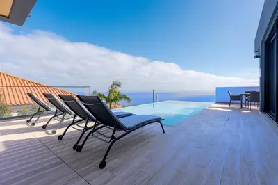 a swimming pool on the roof of a house at Robbie's Place by Holiday Rental Madeira in Santa Cruz