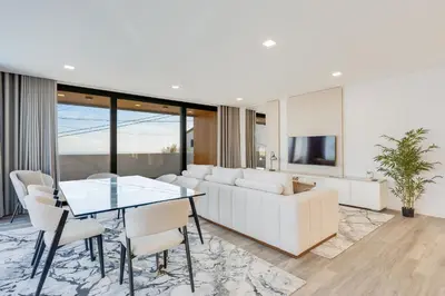 a living room with a white couch and a table at Robbie's Place by Holiday Rental Madeira in Santa Cruz