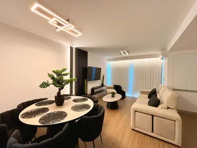 a living room with a table and a couch at Star Light Apartment in Câmara de Lobos