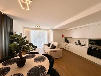 a living room with a couch and a table in a room at Star Light Apartment in Câmara de Lobos