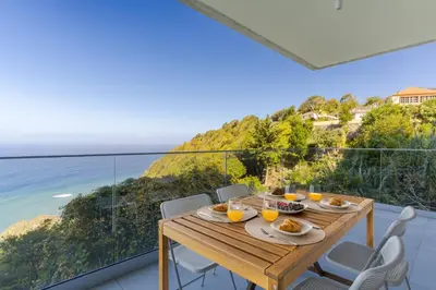 a dining table with a view of the ocean at Mar Yam Sea - Ocean View by Atlantic Holiday in Arco de São Jorge