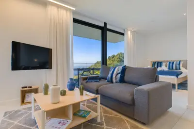a living room with a couch and a tv at Mar Yam Sea - Ocean View by Atlantic Holiday in Arco de São Jorge