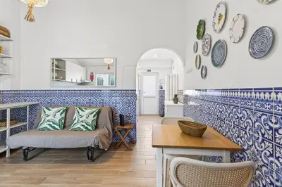 a living room with blue and white tiles at Pátio da Luz 1Bdr House by LovelyStay in Luz